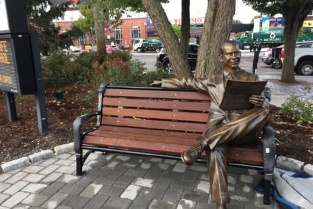 Bronze mayor Paul Amico sitting on a bench memorial statue
