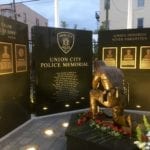 Bronze kneeling police officer statue memorial