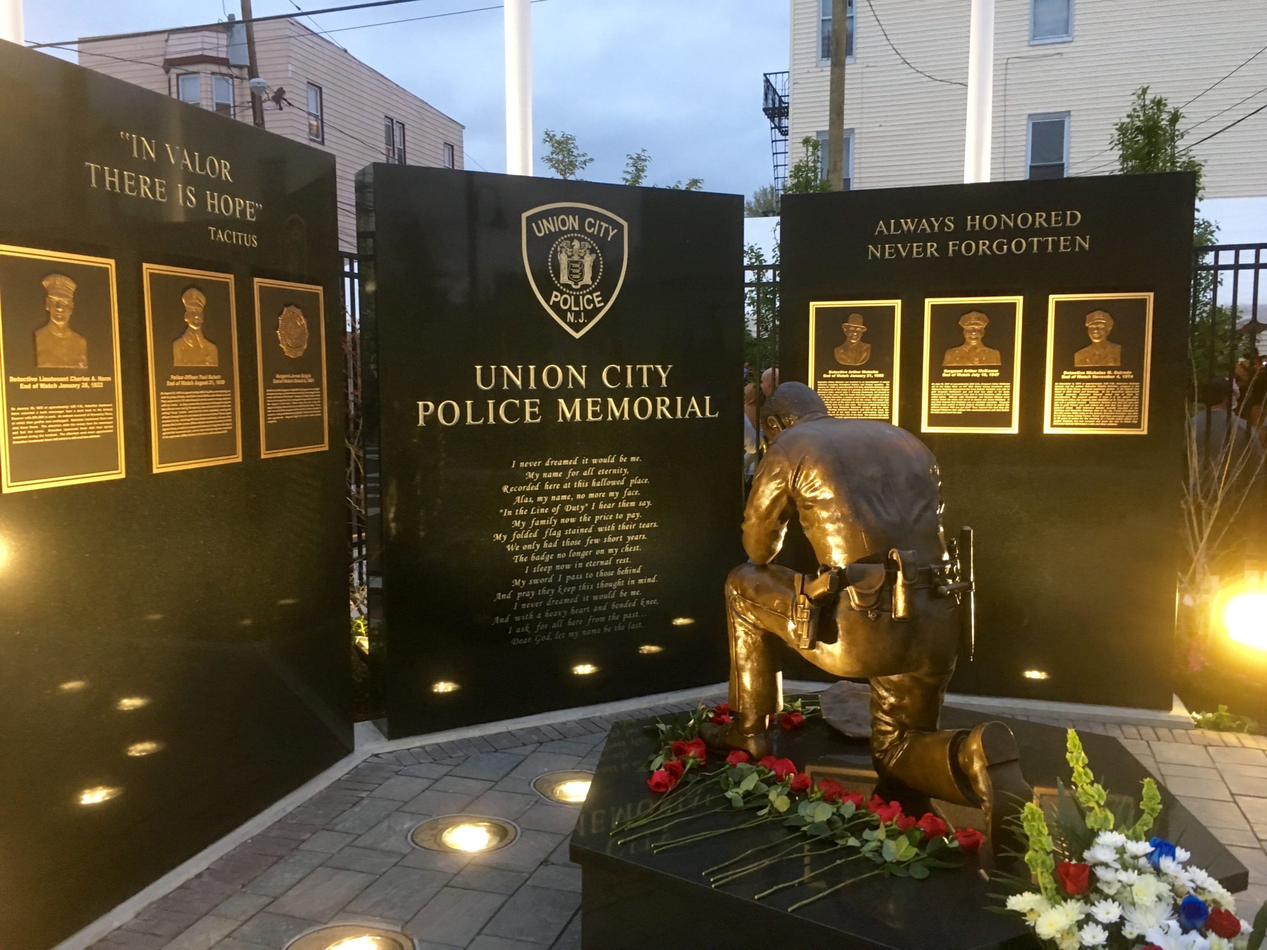 Bronze kneeling police officer statue memorial