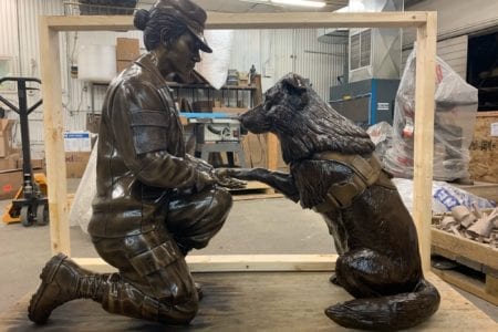 female soldier and k9 statue