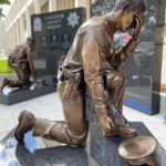 bronze kneeling police officer memorial
