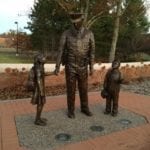 police officer statue with children