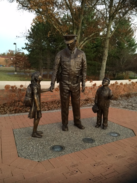 police officer statue with children