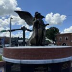angel and fallen officer statue on top of brick memorial structure