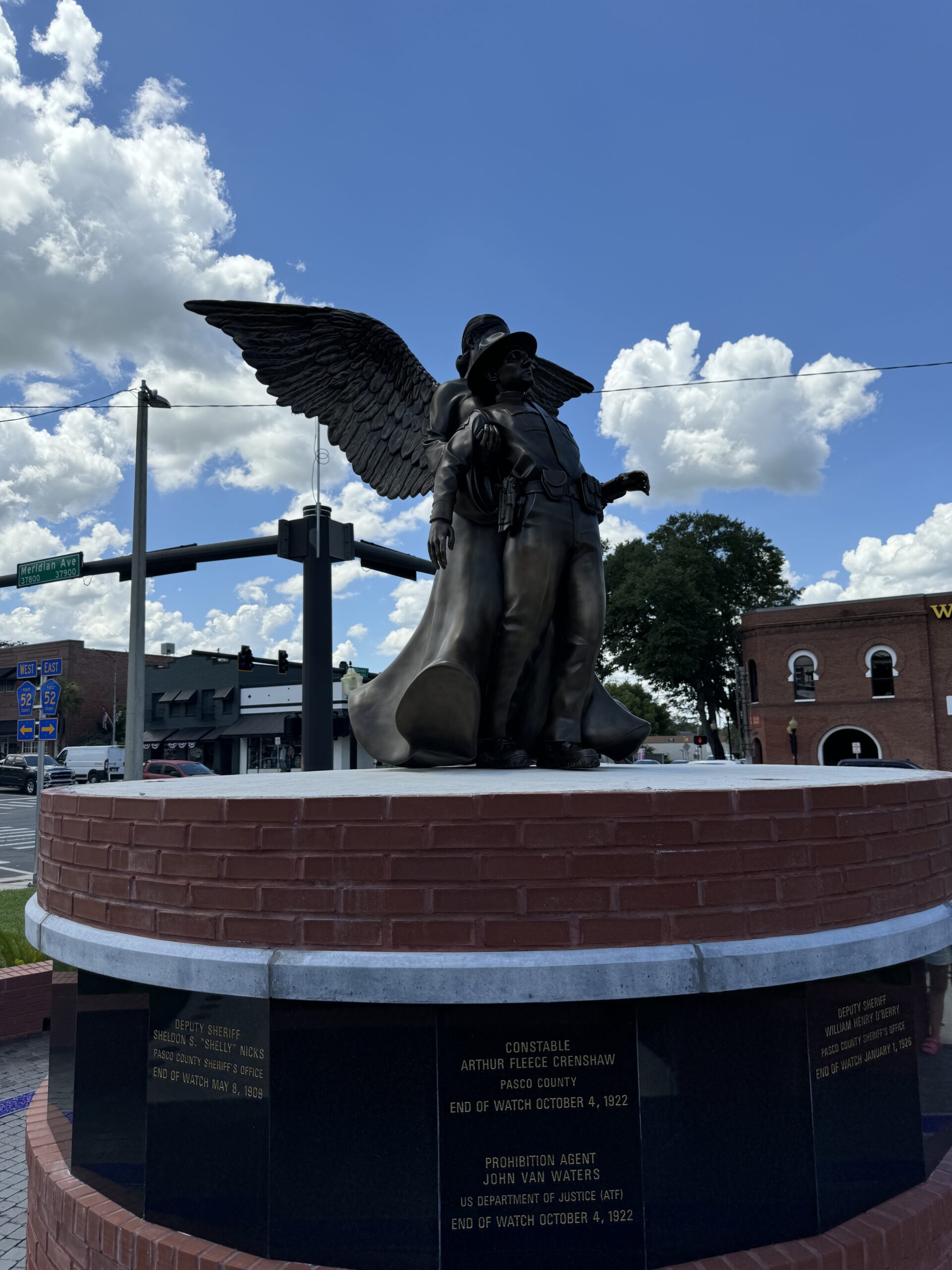 angel and fallen officer statue on top of brick memorial structure