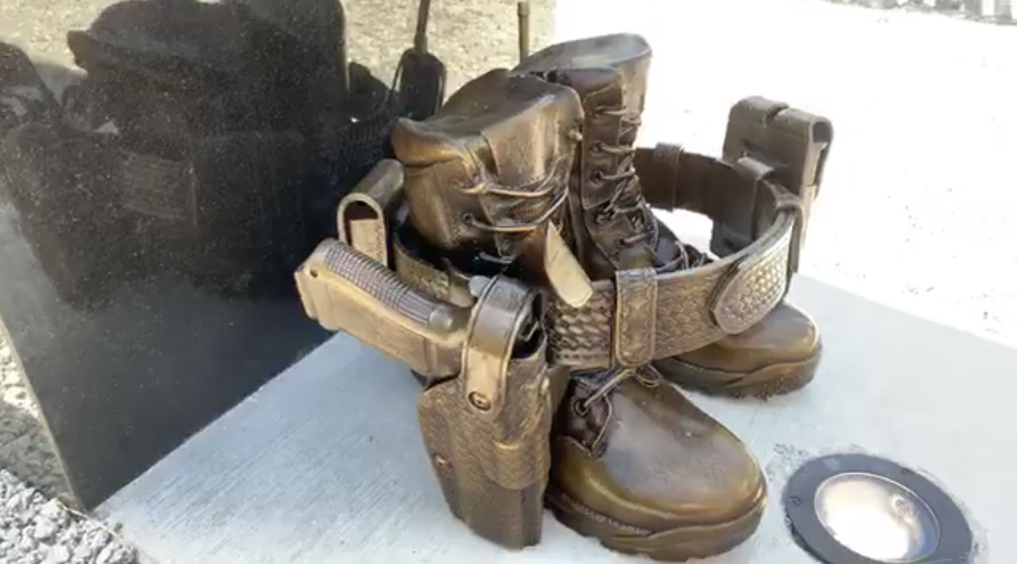 Bronze law enforcement turnout gear, bronze folded flags, bronze law enforcement equipment memorial