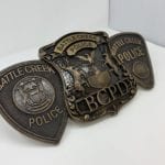 bronze logos on badges for Battle Creek police department