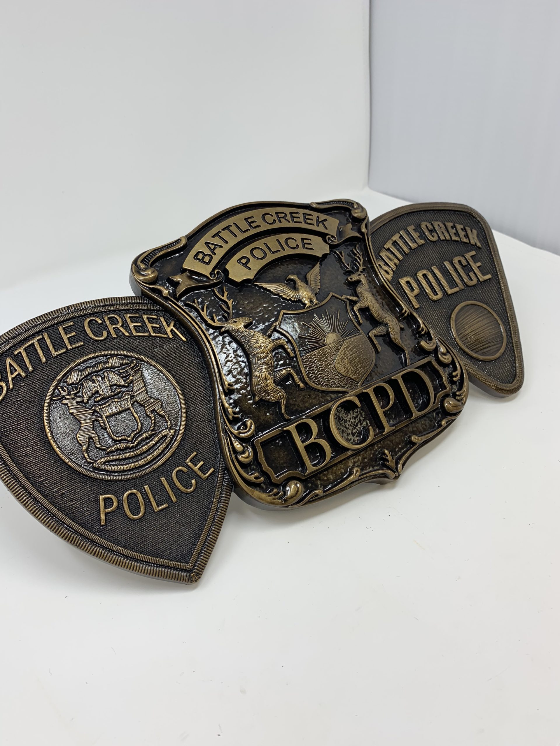 bronze logos on badges for Battle Creek police department