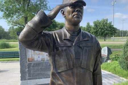 Bronze military memorial saluting soldier statue