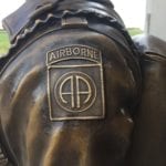 bronze paratrooper statue closeup of arm