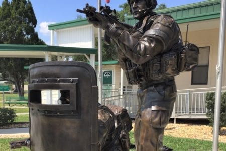 Bronze SWAT operator statues in full gear with shield