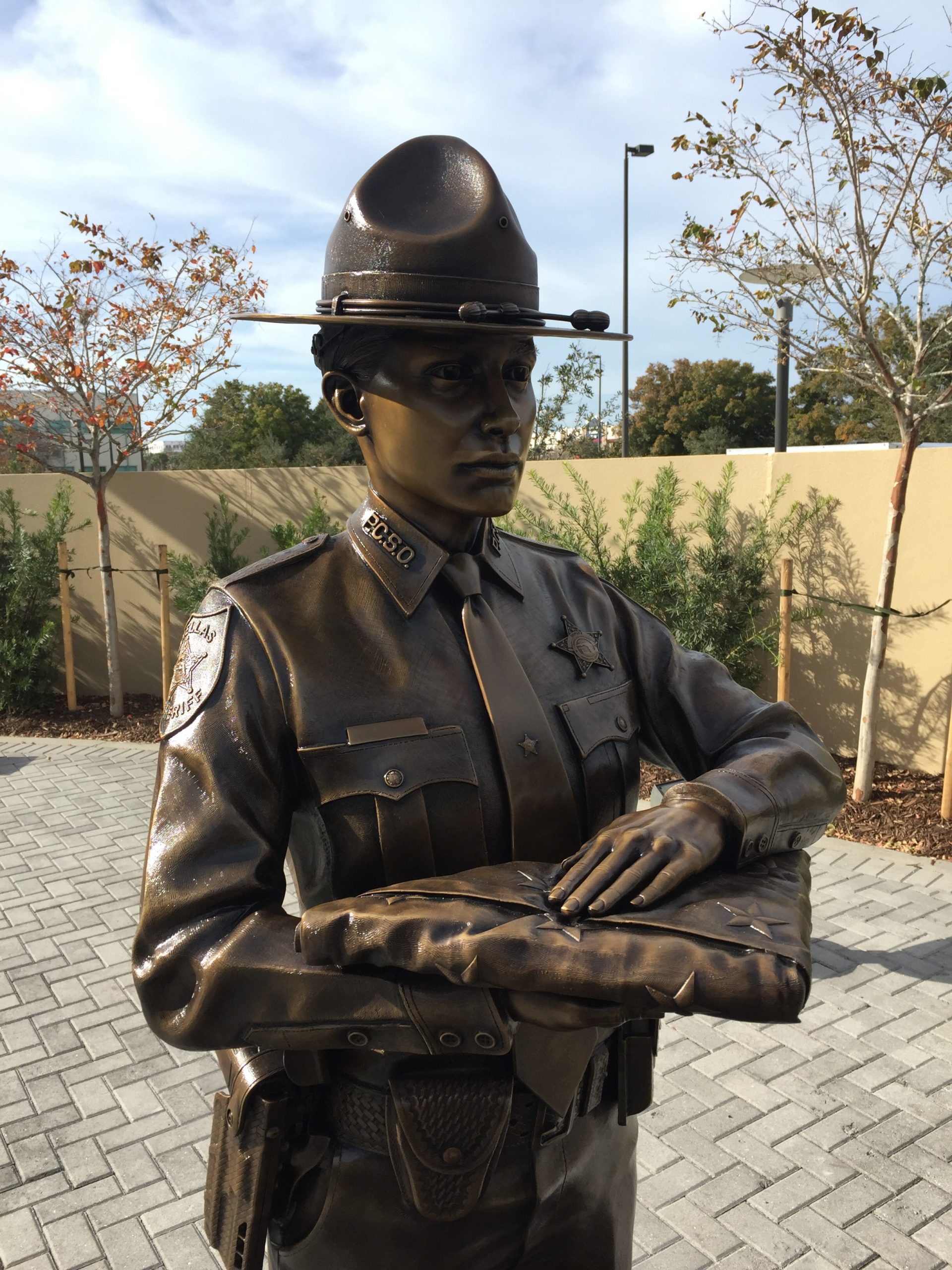 Bronze officer holding American flag