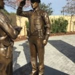 Bronze saluting officer with custom uniform and patches