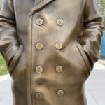 closeup of navy sailor statue peacoat