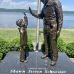 Officer Shawn Schneider giving his son a high-five