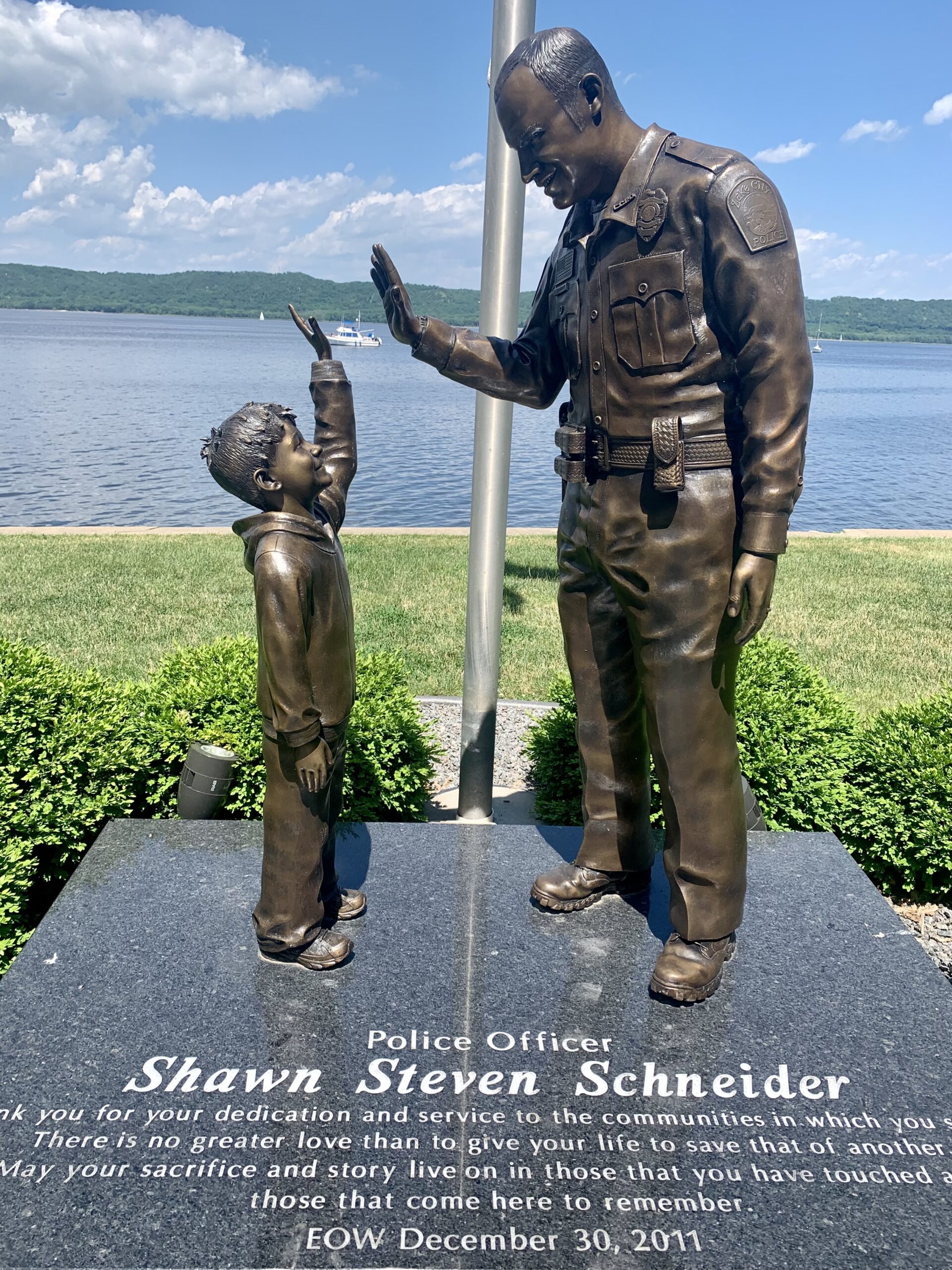 Officer Shawn Schneider giving his son a high-five