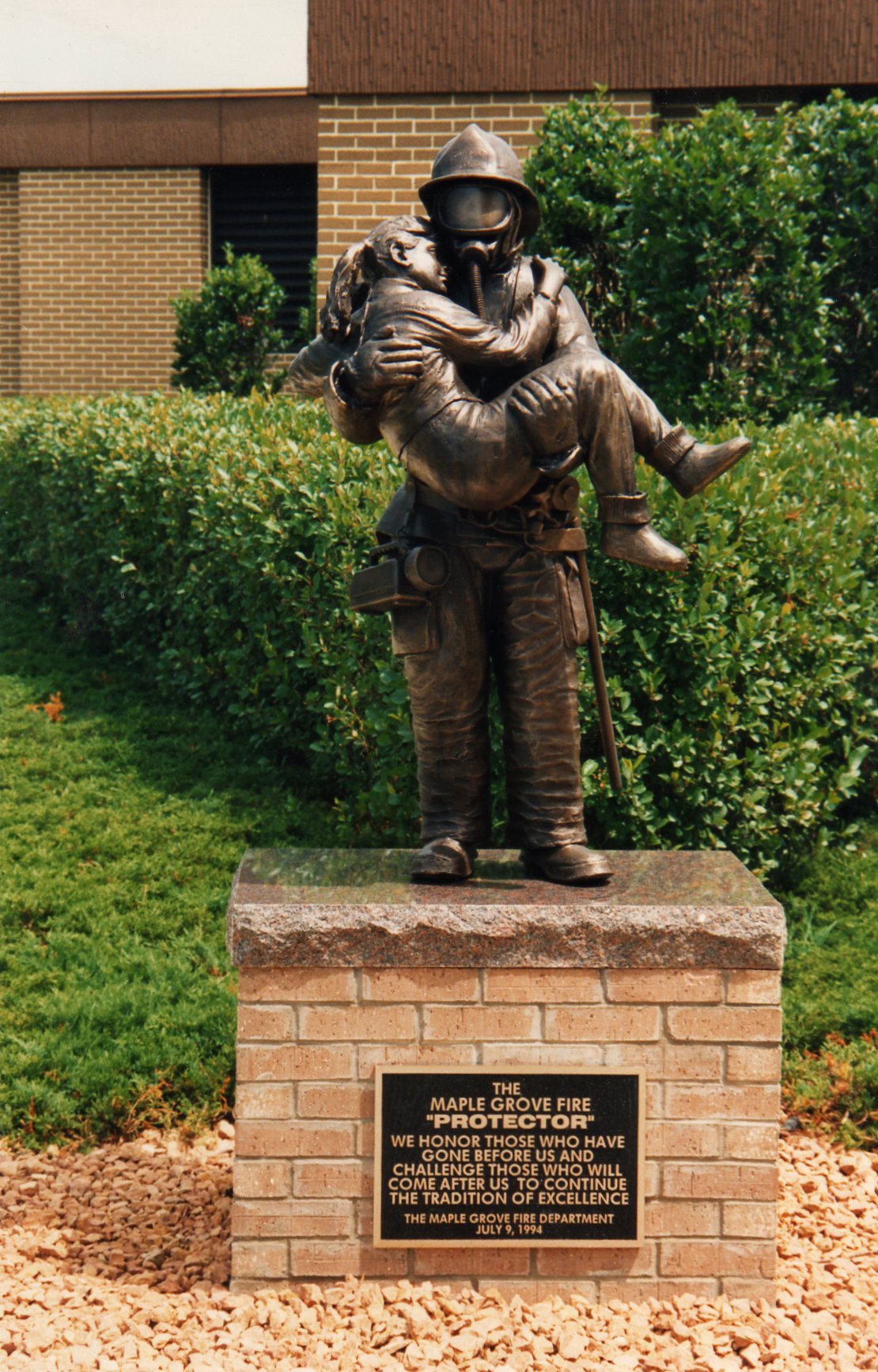 bronze firefighter sculpture on a base