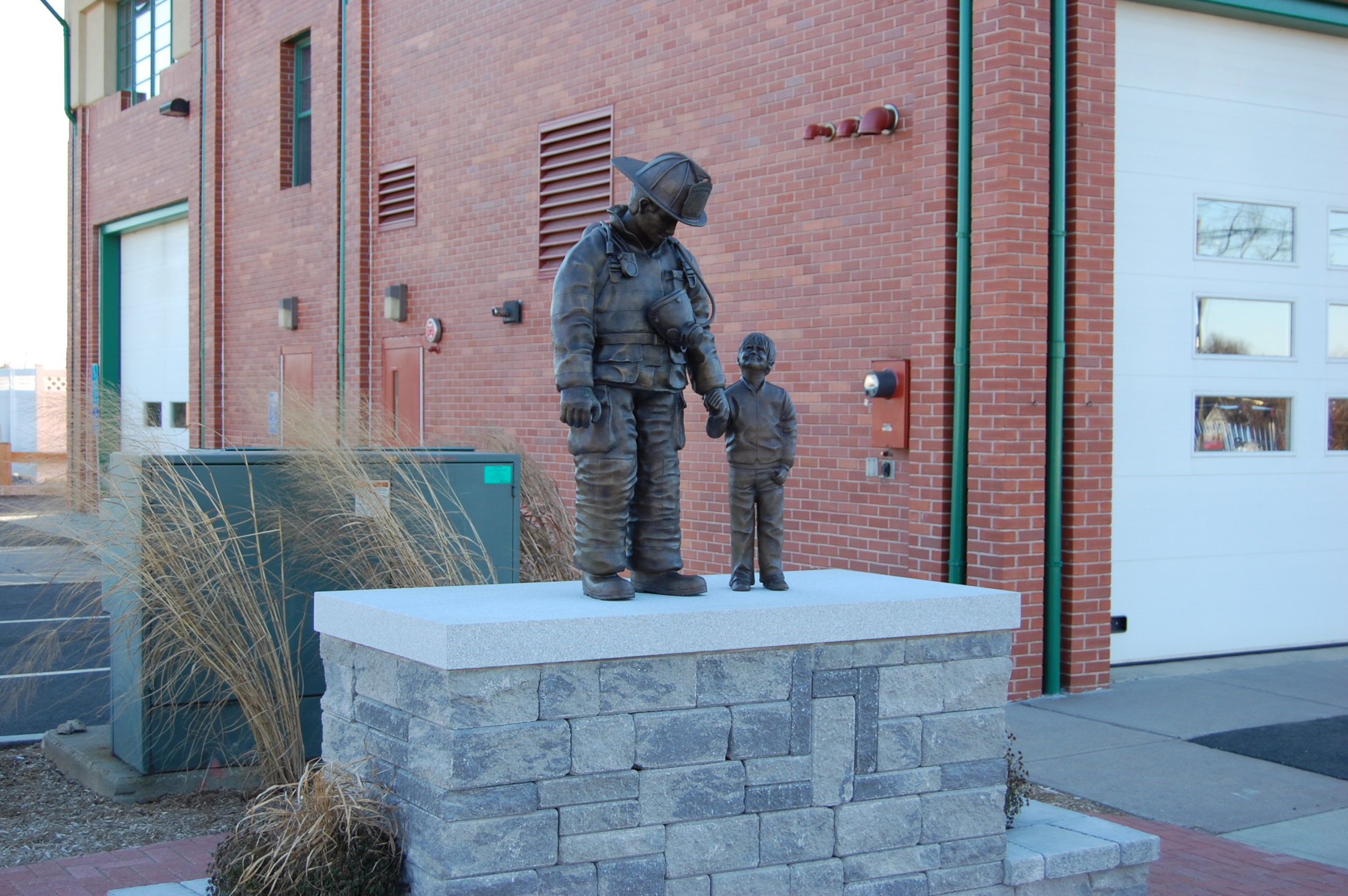 firefighter and child statue on pedestal