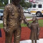 firefighter monument holding child's hand