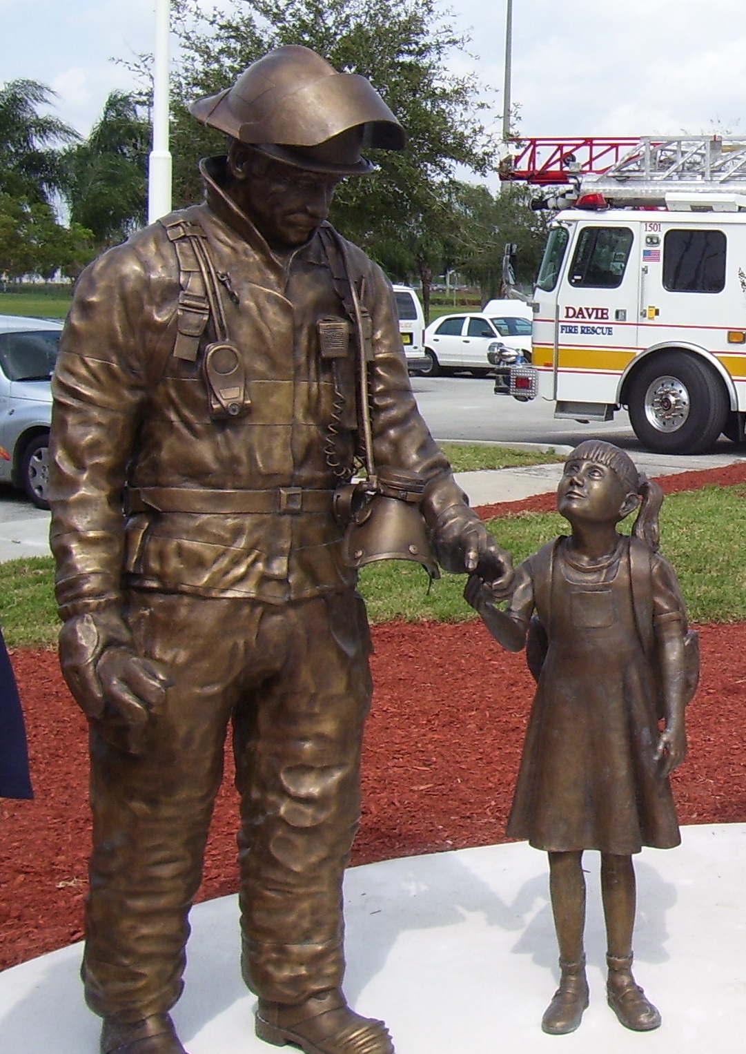 firefighter monument holding child's hand