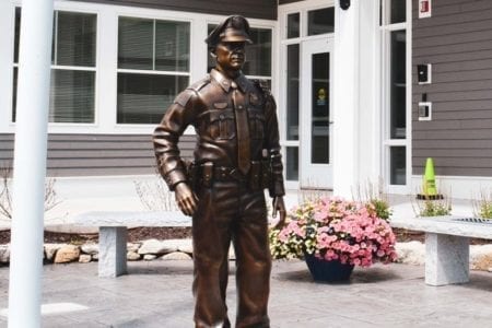 Bronze police officer in uniform statue